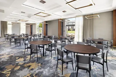 a dining room with tables and chairs at AC Hotel by Marriott Newtown Square in Newtown Square