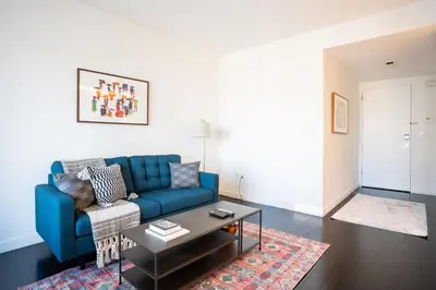 a living room with a blue couch and a coffee table at Tribeca 1br w doorman gym roof deck NYC-1374 in New York