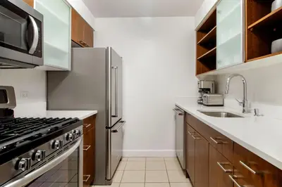 a kitchen with a stainless steel refrigerator and a sink at Chelsea 1br w roofdeck gym nr Flatiron NYC-1384 in New York