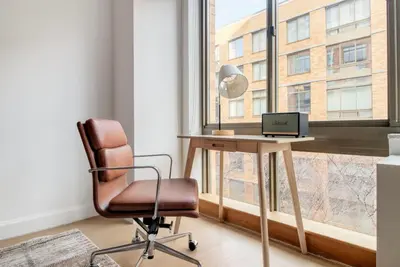 a office with a desk and a chair and a window at Chelsea 1br w roofdeck gym nr Flatiron NYC-1384 in New York