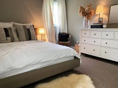 a bedroom with a bed with a dresser and a mirror at private luxe, garden, wellness home steps from Princeton in Franklin Park