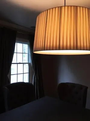 a lamp in a room with a table and a window at private luxe, garden, wellness home steps from Princeton in Franklin Park