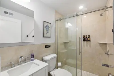 a bathroom with a shower and a toilet and a sink at Stay at Luna at Convention Center in Philadelphia