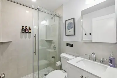 a bathroom with a shower and a toilet and a sink at Stay at Luna at Convention Center in Philadelphia