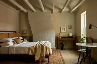 a bedroom with a bed and a brick wall at Hotel Anna & Bel in Philadelphia