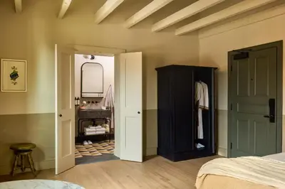 a bedroom with a bed and a closet and a bathroom at Hotel Anna & Bel in Philadelphia