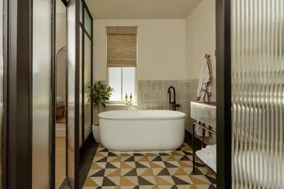a bathroom with a large white tub in a room at Hotel Anna & Bel in Philadelphia