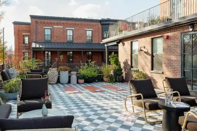 a patio with chairs and tables and a building at Hotel Anna & Bel in Philadelphia