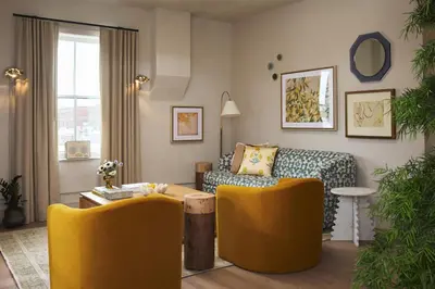 a living room with yellow chairs and a couch at Hotel Anna & Bel in Philadelphia