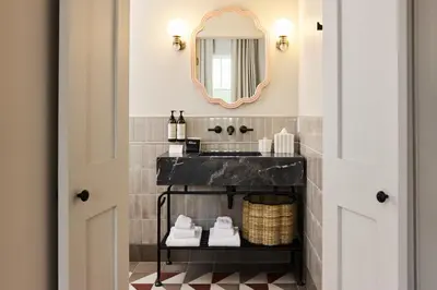 a bathroom with a black sink and a mirror at Hotel Anna & Bel in Philadelphia