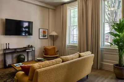 a living room with a couch and a tv at Hotel Anna & Bel in Philadelphia