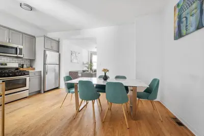 a kitchen and dining room with a table and chairs at Modern Home 4BR 3BA - 20 Min to Timesquare in Jersey City