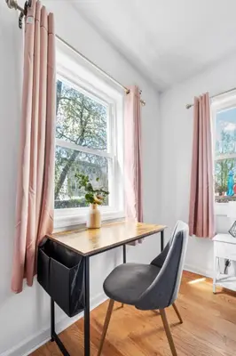 a desk and a chair in a room with a window at Modern Home 4BR 3BA - 20 Min to Timesquare in Jersey City