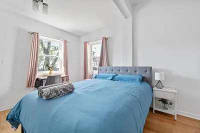a bedroom with a large bed with blue sheets at Modern Home 4BR 3BA - 20 Min to Timesquare in Jersey City
