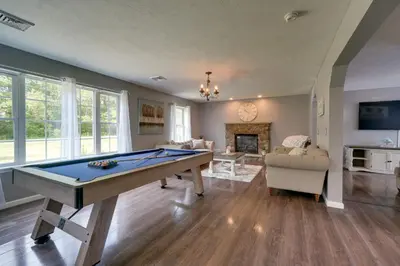 a living room with a pool table in it at 1 Mi to Lakes Family Pocono Home with Yard and Deck! in Long Pond