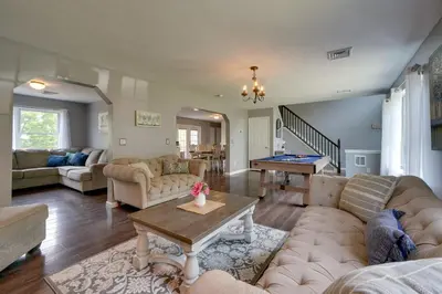 a living room with couches and a pool table at 1 Mi to Lakes Family Pocono Home with Yard and Deck! in Long Pond