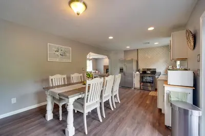 a kitchen and dining room with a table and chairs at 1 Mi to Lakes Family Pocono Home with Yard and Deck! in Long Pond
