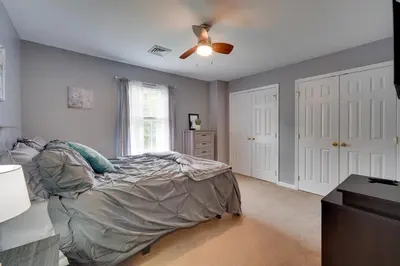 a bedroom with a bed and a ceiling fan at 1 Mi to Lakes Family Pocono Home with Yard and Deck! in Long Pond