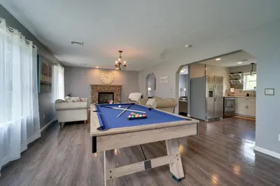 a living room with a pool table in it at 1 Mi to Lakes Family Pocono Home with Yard and Deck! in Long Pond