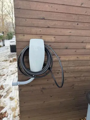 a hose is hooked up to a wall at Modern Mid-Century Retreat in West Chester