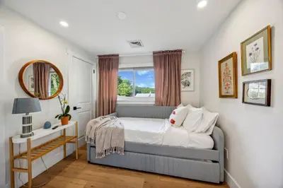 a bedroom with a bed and a window at Modern Mid-Century Retreat in West Chester