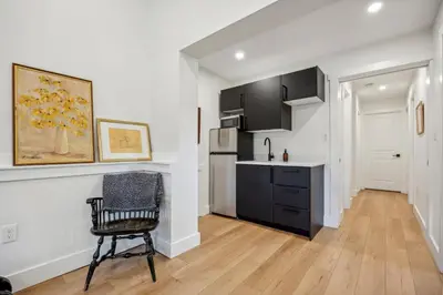 a kitchen with a table and a chair in a room at Modern Mid-Century Retreat in West Chester