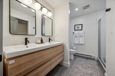 a bathroom with a sink and a mirror at Modern Mid-Century Retreat in West Chester