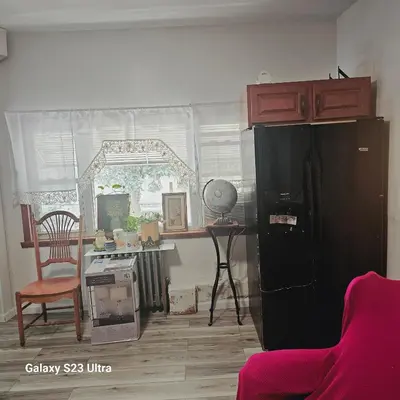 a kitchen with a black refrigerator and a table at HARPER AVE King Bed with Private Bathroom, FREE PARKING in Irvington