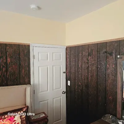 a room with wood paneled walls and a door at HARPER AVE King Bed with Private Bathroom, FREE PARKING in Irvington