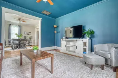a living room with a couch and a tv at The Farm House in Dillsburg