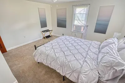 a bedroom with a large bed and a window at The Farm House in Dillsburg