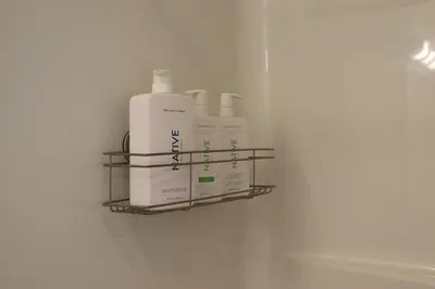 a shelf with four bottles of soap on a wall at Penn's Creek Symphony in Spring Mills