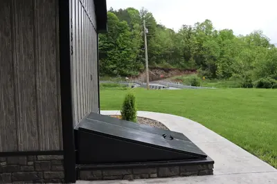 a window on the side of a building with a plant at Penn's Creek Symphony in Spring Mills