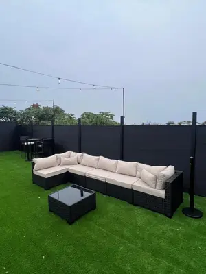 a couch sitting on the grass on a rooftop at Bay Ridge ApartHotel in Brooklyn