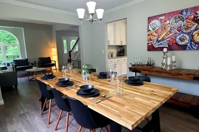 a dining room with a wooden table with chairs at Perfect Vacation Home with Game Room Theater Hot Tub in Tobyhanna