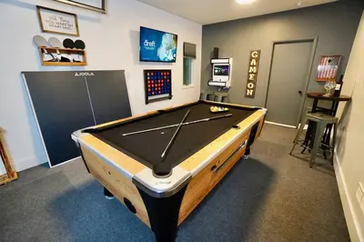 a ping pong table in a room with ahibition at Poconos Oasis with Game Room in Pocono Summit