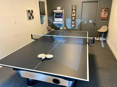 a ping pong table with two spoons on top of it at Poconos Oasis with Game Room in Pocono Summit