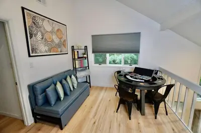 a room with a table and a couch and a laptop at Poconos Oasis with Game Room in Pocono Summit