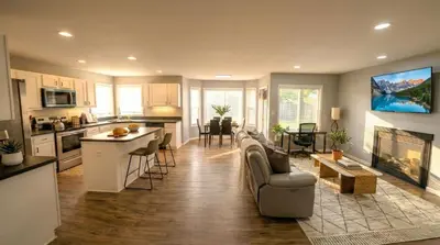 a kitchen and living room with a couch and a table at Cozy Modern Villa in New Castle