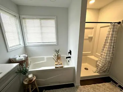 a white bathroom with a tub and a shower at Cozy Modern Villa in New Castle