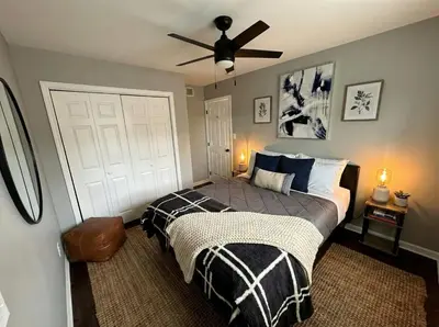 a bedroom with a bed and a ceiling fan at Cozy Modern Villa in New Castle