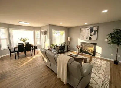 a living room with a couch and a dining room at Cozy Modern Villa in New Castle