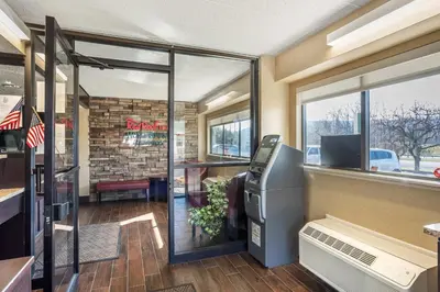 an empty restaurant with a cash register and a window at HomeTowne Studios by Red Roof Danville, PA in Danville