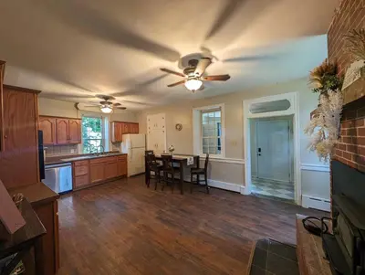 a large kitchen with a table and a ceiling fan at The Hidden Homestead in Lebanon
