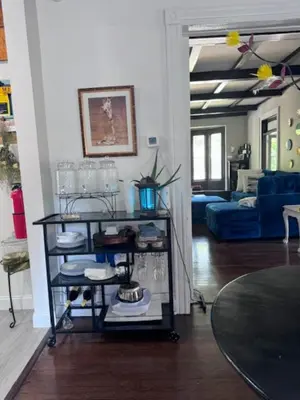a living room with a table and a blue couch at Bloom Victorian Bed & Breakfast in South Orange