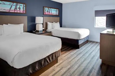 a hotel room with two beds and a flat screen tv at Hyatt House Philadelphia/Plymouth Meeting in East Norriton