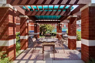 a patio with a table and chairs under a pergola at Hyatt House Philadelphia/Plymouth Meeting in East Norriton