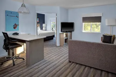 a hotel room with a bed and a desk and a couch at Hyatt House Philadelphia/Plymouth Meeting in East Norriton
