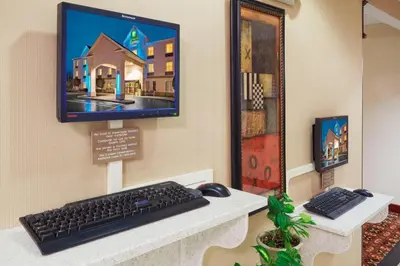 a computer monitor and a keyboard and mouse on a desk at Holiday Inn Express Frackville Hotel By IHG in Frackville