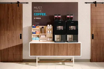 a coffee shop with a counter with a coffee maker at Holiday Inn Express Frackville Hotel By IHG in Frackville